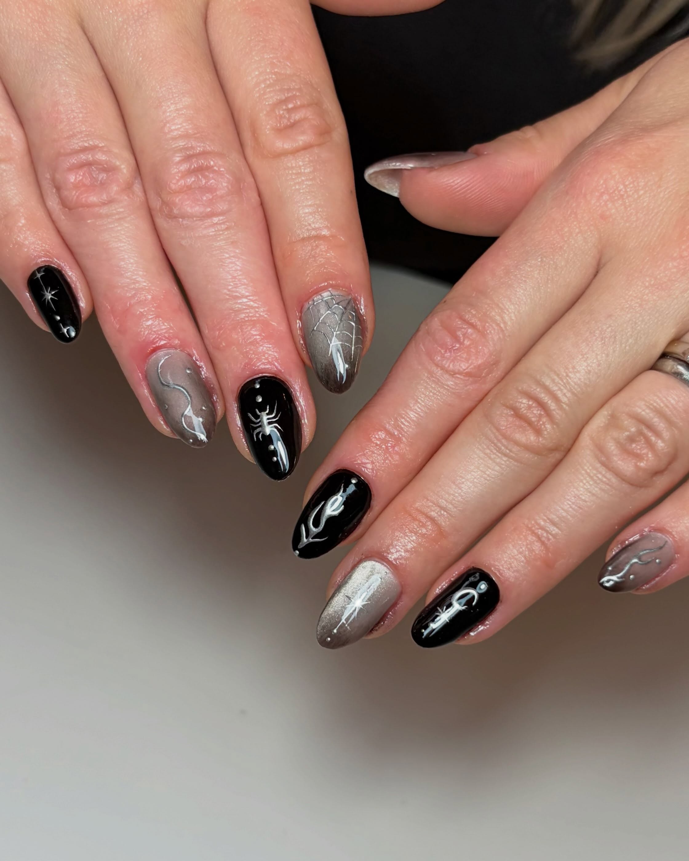 Black cat eye and silver chrome Halloween nails