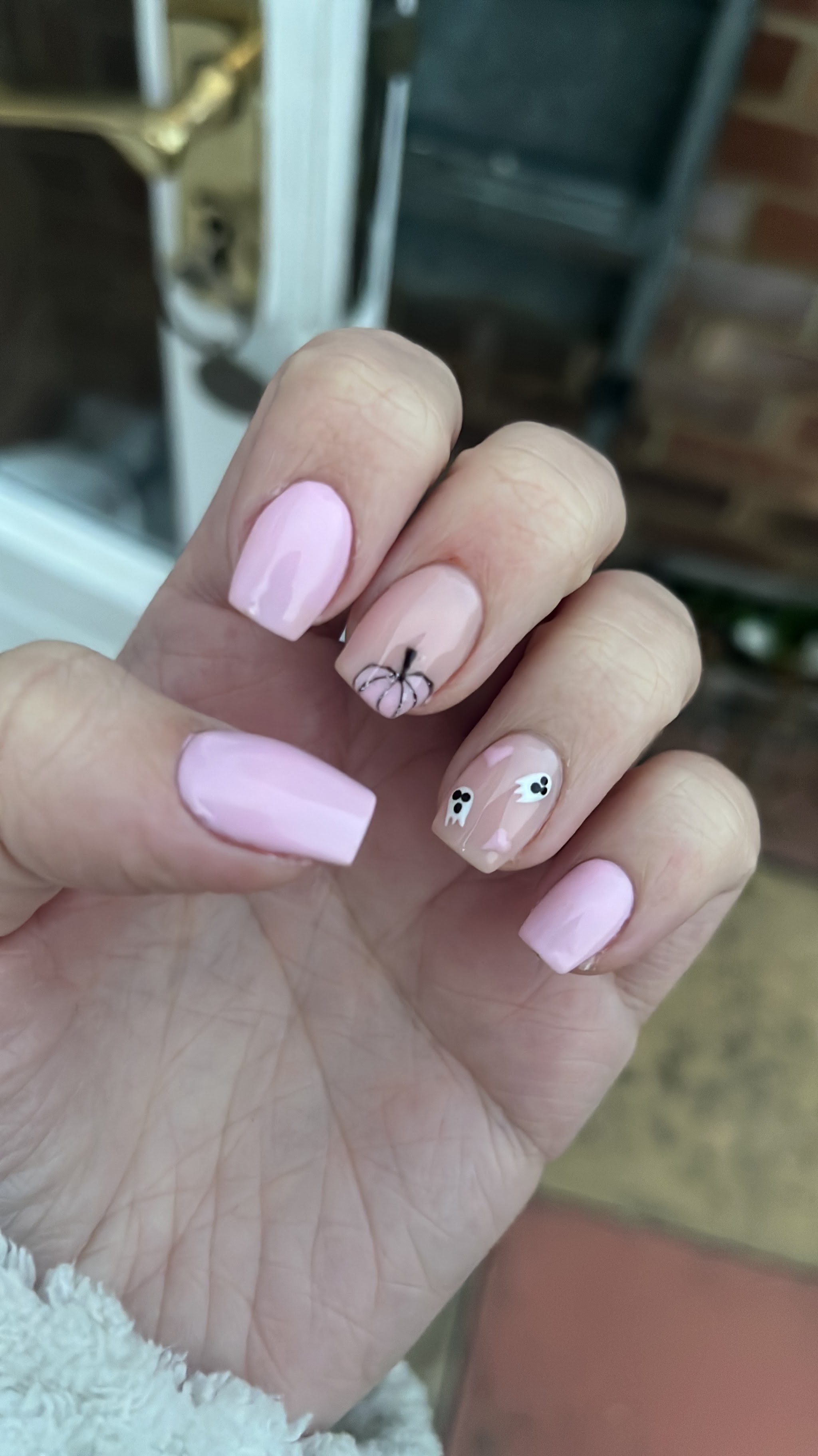 Pastel pink nails with a little Halloween ghost accent