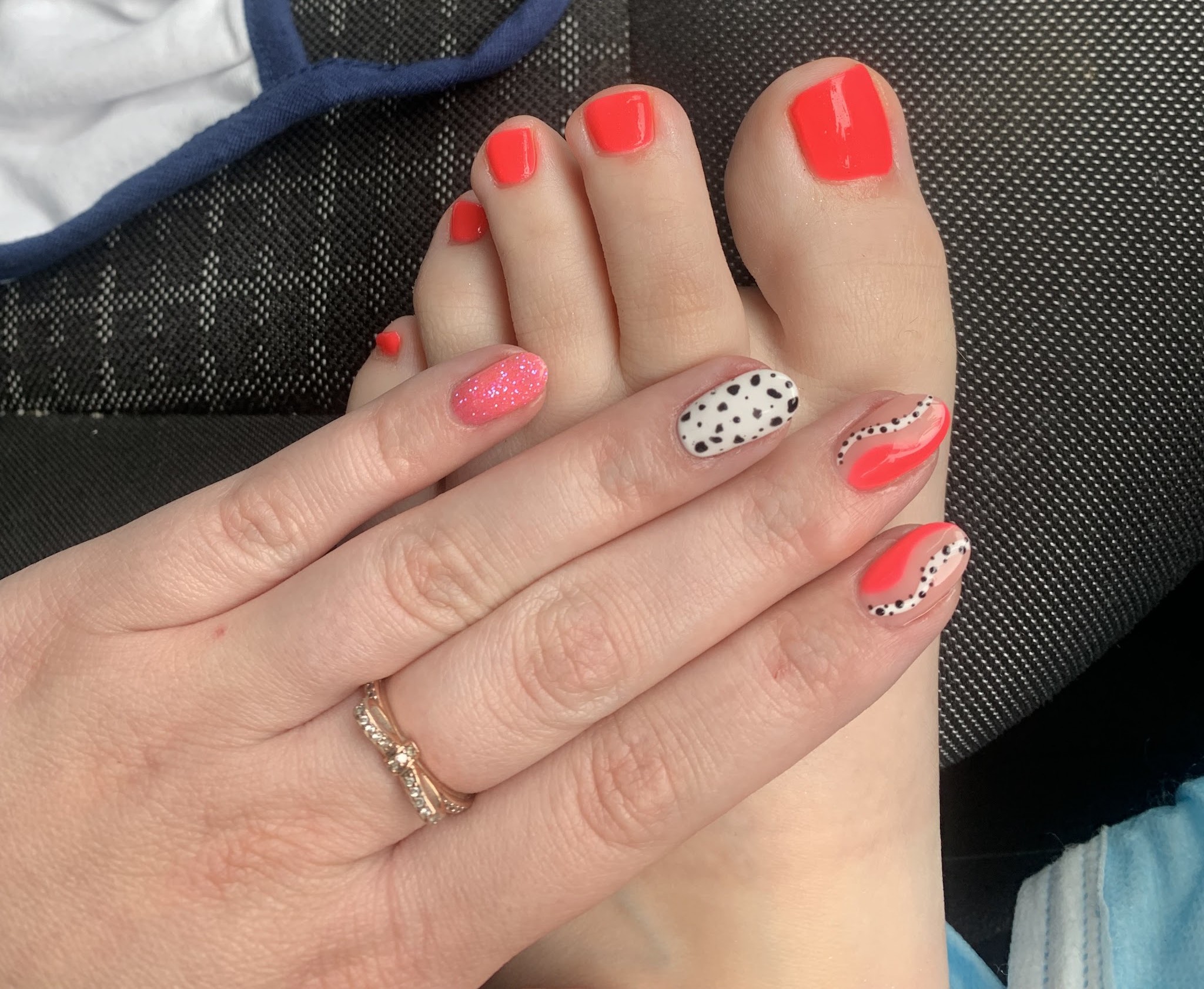 Coral gel toes with matching hand nails and polka dot accents