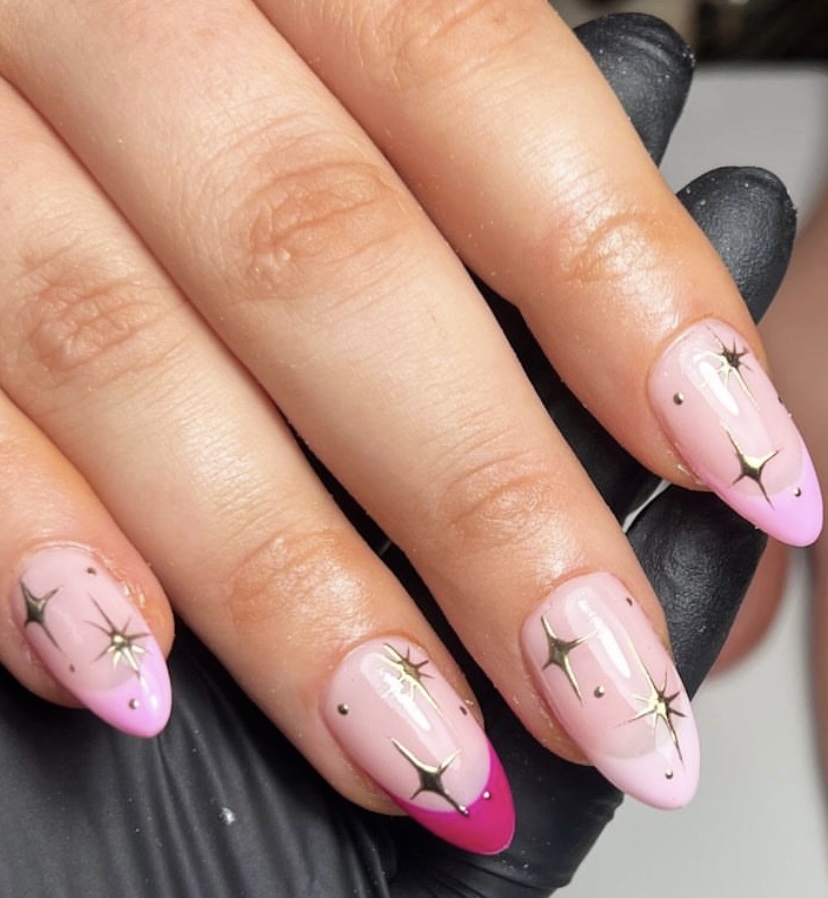 Pink almond nails with gold star art